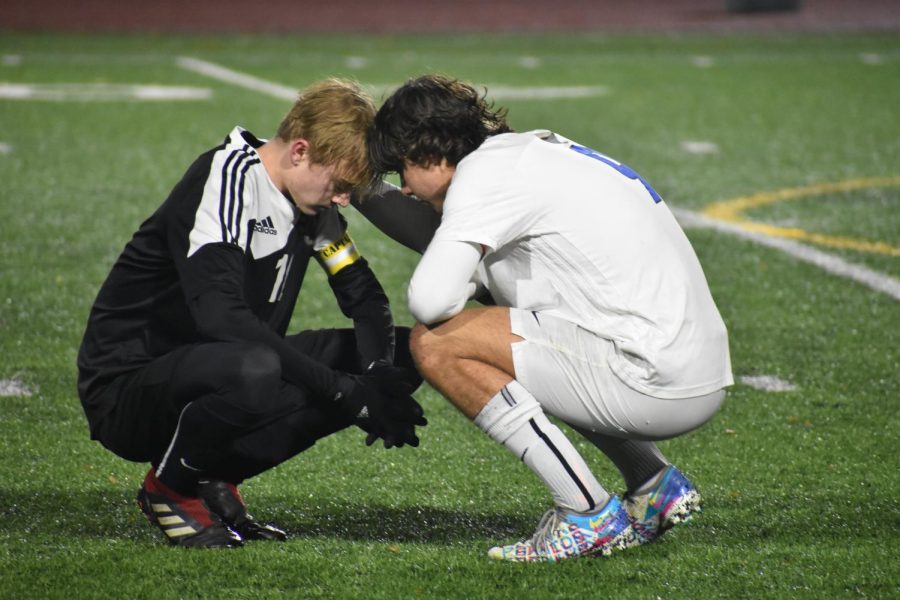 Varsity+soccer+captain+Charlie+Lucero+%28right%29+consoling+a+Silver+Creek+player+following+a+playoff+game.