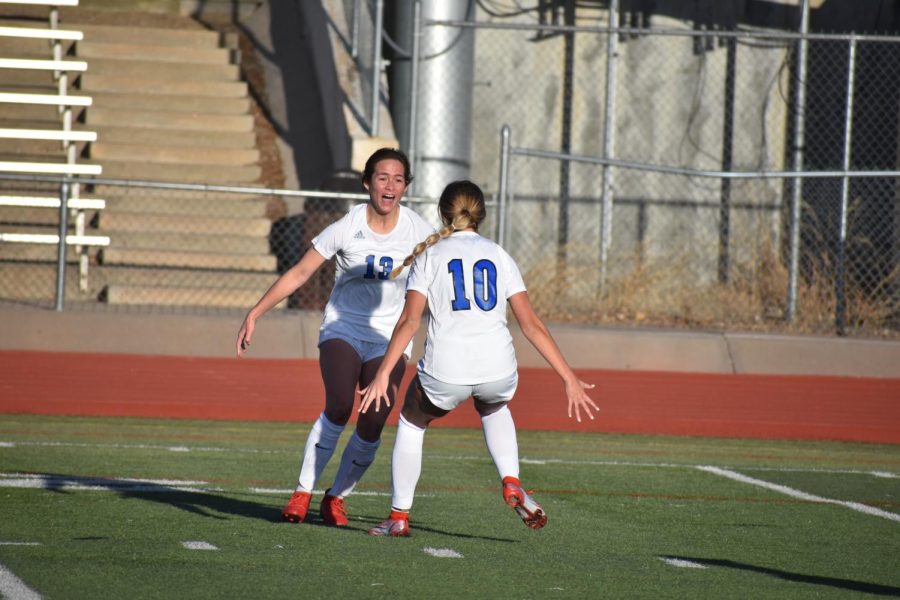 Kea Barnes (13) and Taylor Held (10) celebrating with each other after a goal  was scored.