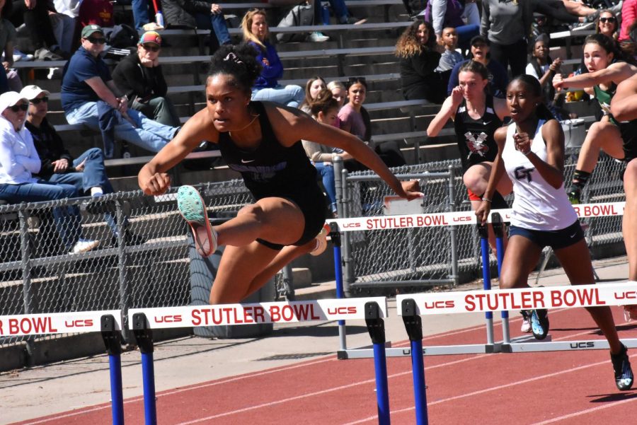 Gabriella Cunningham jumping over a hurdle in the 100M Hurdles event.