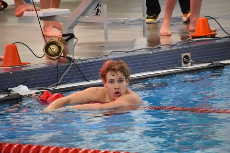 Oliver Schimberg(10) looking for his family after he broke the Cherry Creek Pool record for the 100 backstroke
