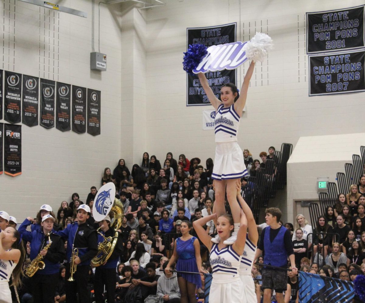 The cheer team performs their chants to the Grandview students in order to show school pride.