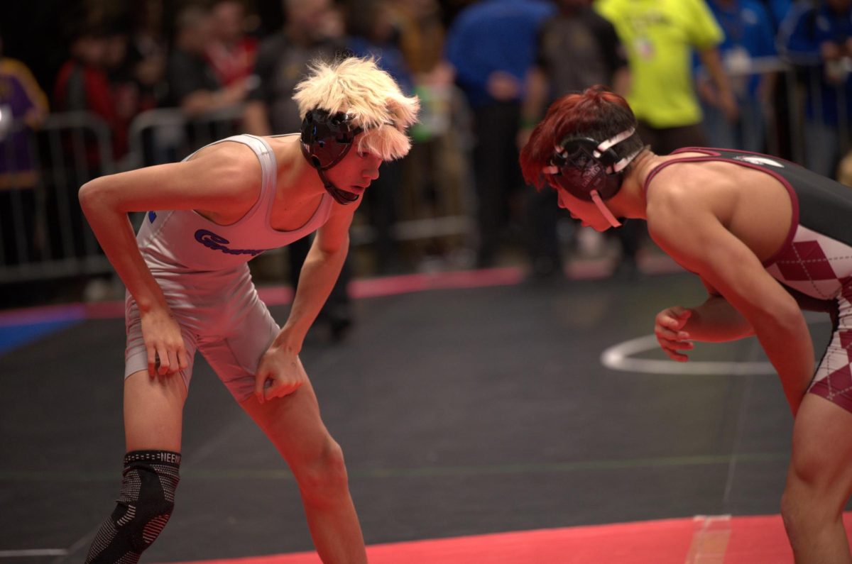 Kyle Meneuz (10) (left) preparing for a match during states on December fifteenth. 