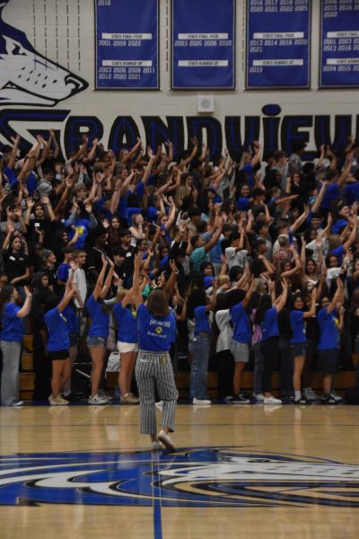 Mrs. Mullenburg, voice of the Wolf Pack! With the class of 2029 gathered in full force, she commands the pep rally with passion and energy. 