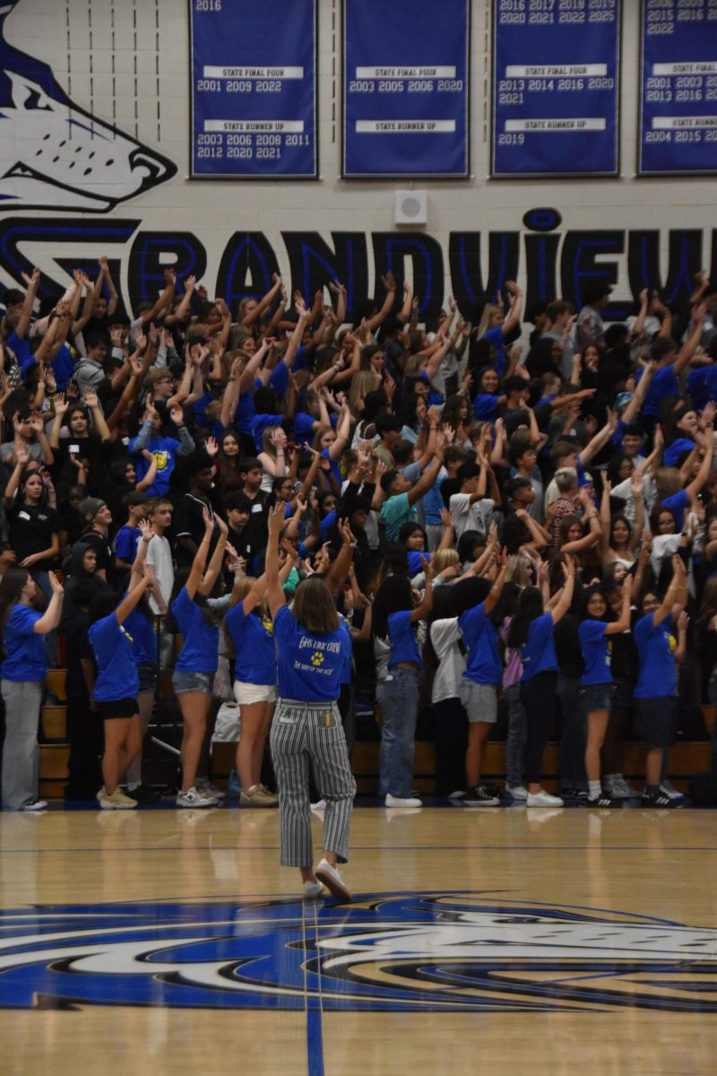 Mrs. Mullenburg, voice of the Wolf Pack! With the class of 2029 gathered in full force, she commands the pep rally with passion and energy. 