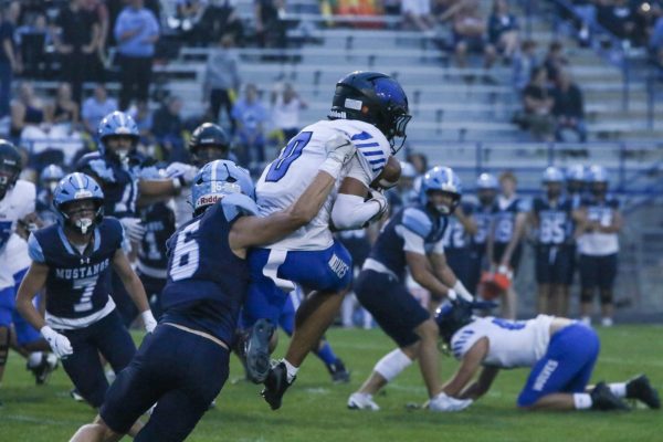 Junior wide reciever Jaxson Flores makes a jumping catch against Ralston Valley on september 4th. Flores secured a first down with this catch to keep the chains moving and eventually led to the Wolves first touchdown of the game.