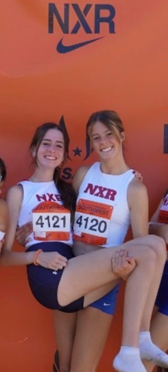 Emerson Hensler (11) holds up Maria Hiatt (11) after competing at NXR in Arizona 