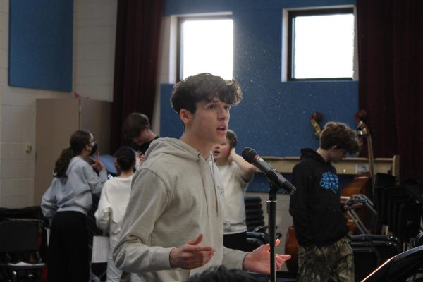 Getting ready, Matthew Korte (11) warms up his voice during sitz-probe for the upcoming play on November 14th. On opening night Korte put on a performance capturing Prince Topher’s character. “I was singing a song called Loneliness of Evening, and it’s difficult to sing, and also it’s complicated to perform. So I’m pretty nervous for that one, but I’m mostly excited for it because it’s a really great song,” Korte said. 