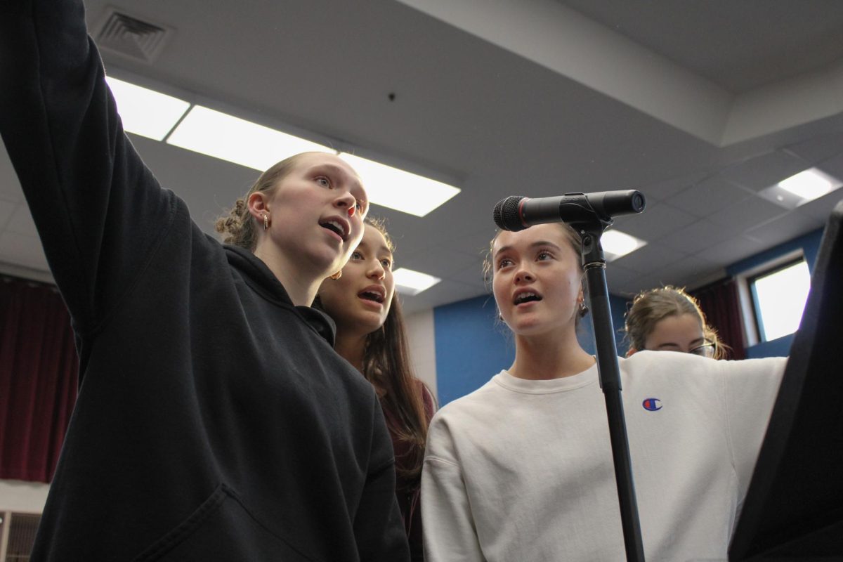 Practicing with the orchestra, Eliza Allred (11), Elliot Kitishima (11), and Kari Rodriguez-Cortez (11)  sing and perform for opening night. Rodriguez-Cortez stepped on stage excited to be a lead with some of her best friends. “They don’t know that Cinderella goes to the ball, but it’s such a fun scene, because it’s where they forget that she’s lower than them,” Rodriguez-Cortez said.