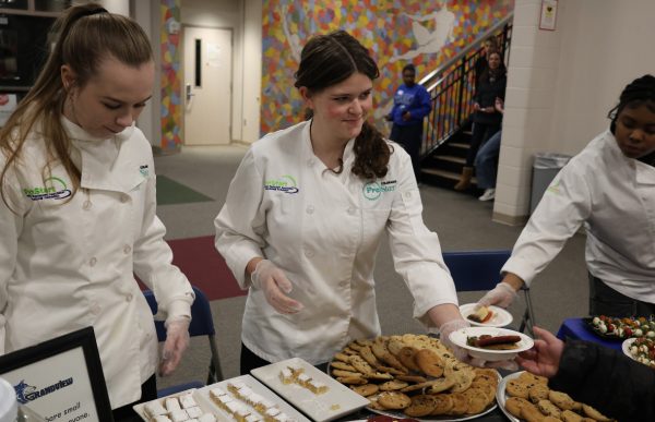 Culinary students share what they’ve learned, offering samples to visiting families.