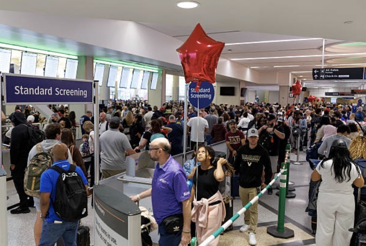 Travelers wait in line at a Transportation Security Administration (TSA) checkpoint at William P. Hobby Airport in Houston, Texas, US, on Monday, March 9, 2026. Airports in the US are reporting longer-than-normal wait times in security lines, as Transportation Security Administration agents are poised to miss their first full paycheck this week.